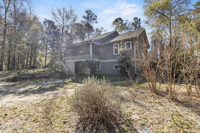 view of property exterior featuring a sunroom
