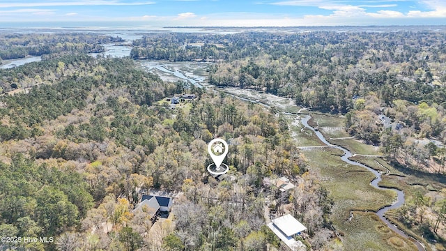 aerial view of property's location featuring a forest