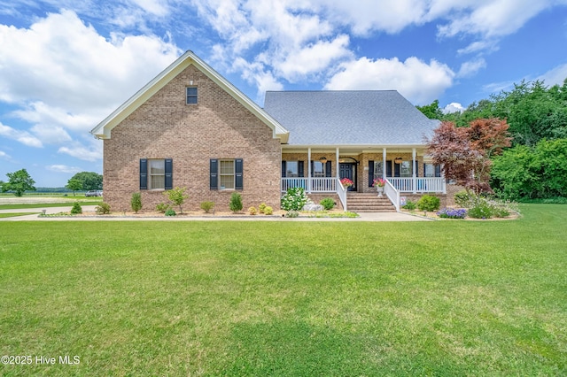 view of front of property with brick siding, a porch, and a front lawn