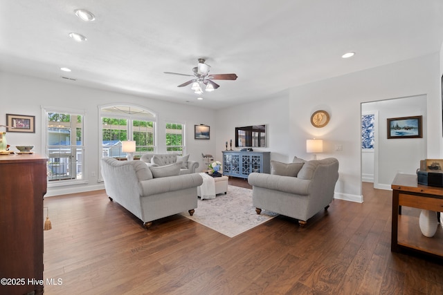 living area with recessed lighting, a ceiling fan, baseboards, and dark wood-style flooring