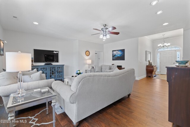 living room featuring dark wood-type flooring, recessed lighting, baseboards, and visible vents