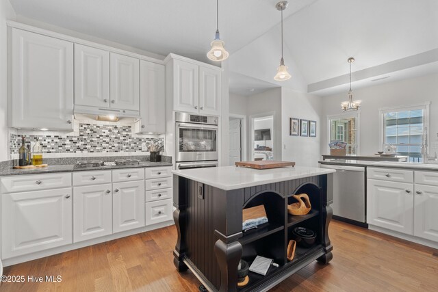 kitchen featuring open shelves, stainless steel appliances, white cabinets, light wood finished floors, and lofted ceiling