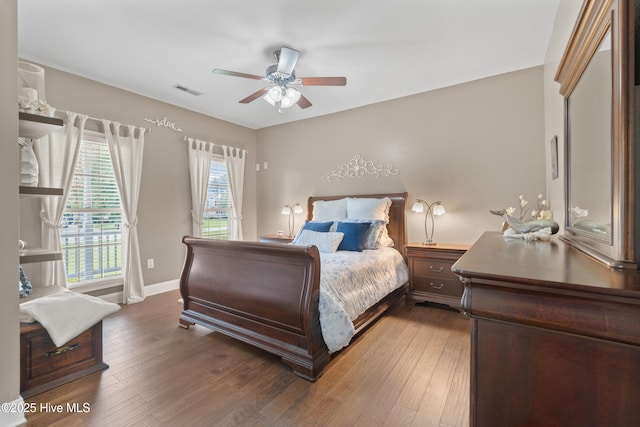 bedroom featuring hardwood / wood-style floors, a ceiling fan, visible vents, baseboards, and access to outside