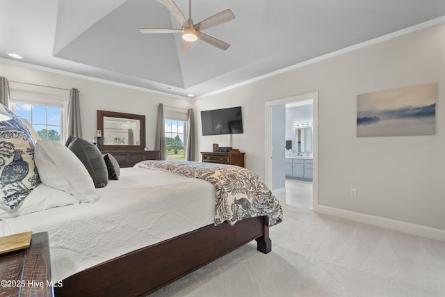 bedroom featuring connected bathroom, baseboards, light colored carpet, vaulted ceiling, and ornamental molding