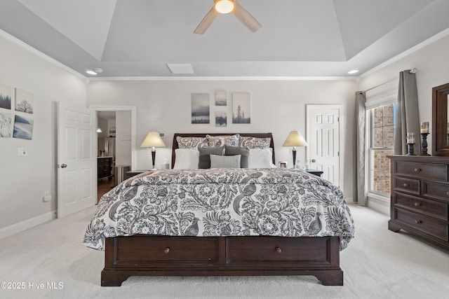 bedroom with a ceiling fan, baseboards, ornamental molding, light carpet, and a raised ceiling