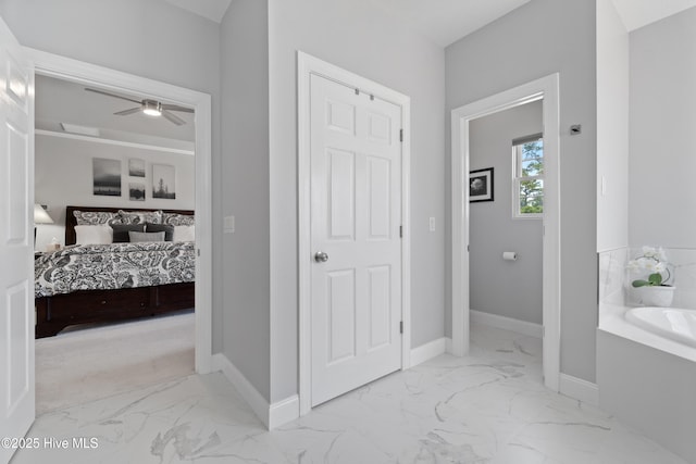 hall with baseboards and marble finish floor