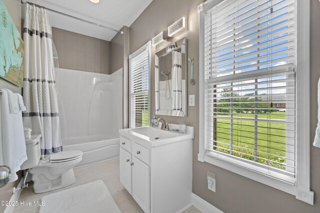 bathroom with toilet, a healthy amount of sunlight, shower / bath combo, and vanity