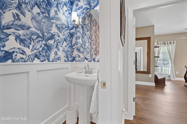 bathroom featuring a sink, baseboards, and wood finished floors