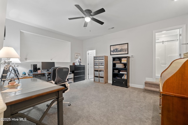 office area with baseboards, carpet, visible vents, and ceiling fan