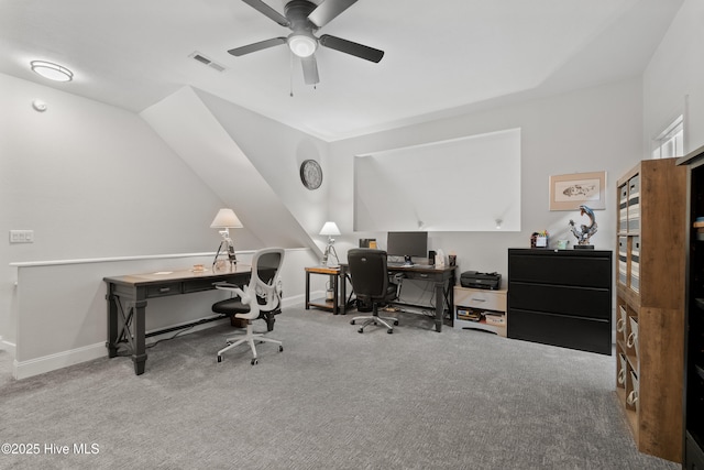 home office featuring visible vents, lofted ceiling, a ceiling fan, carpet floors, and baseboards