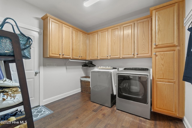 laundry room with cabinet space, independent washer and dryer, dark wood-type flooring, and baseboards