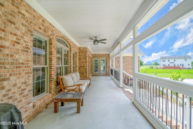 sunroom / solarium with a ceiling fan