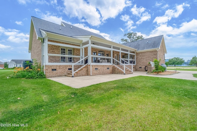 back of house featuring concrete driveway, a yard, brick siding, and crawl space