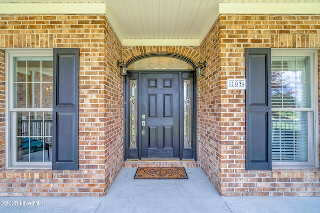 entrance to property with brick siding