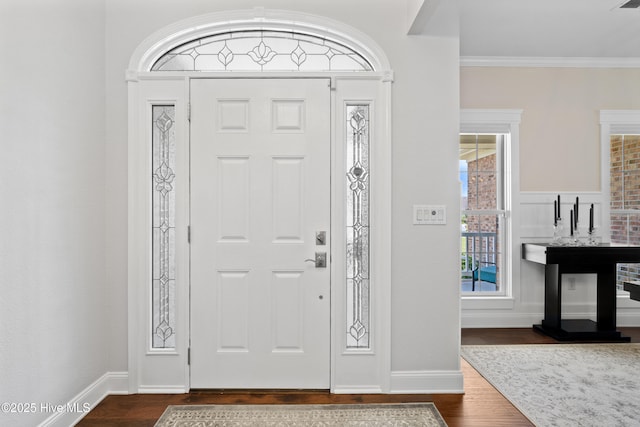 entryway featuring crown molding, dark wood-style floors, and baseboards