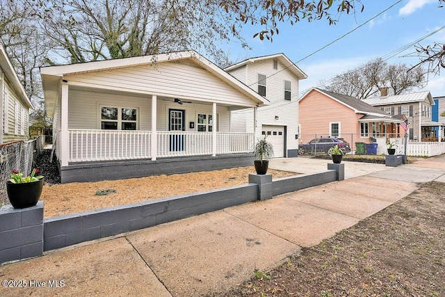 view of front of house featuring a garage, covered porch, concrete driveway, and fence