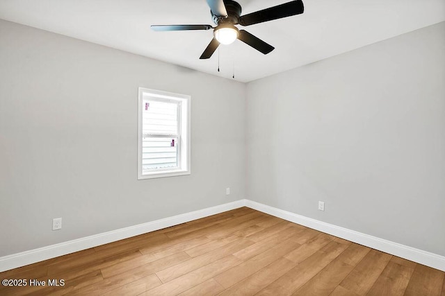 unfurnished room with ceiling fan, baseboards, and wood finished floors