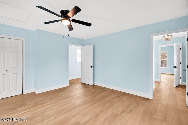 unfurnished bedroom with a closet, baseboards, and light wood finished floors