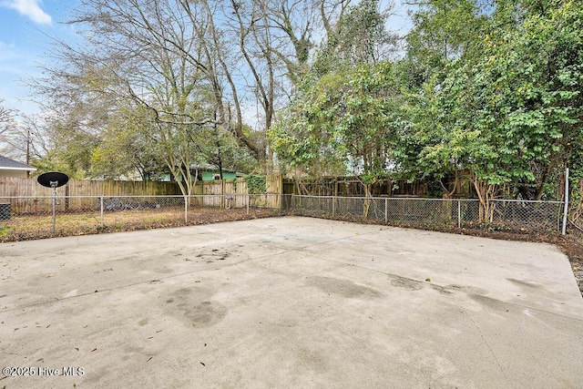 view of patio / terrace featuring community basketball court and fence