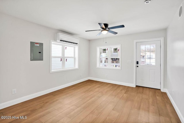 foyer with light wood-style flooring, electric panel, a healthy amount of sunlight, and a wall mounted air conditioner