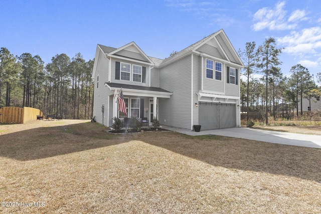 traditional-style house with covered porch, concrete driveway, and an attached garage