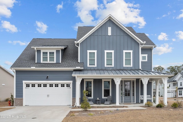 modern farmhouse featuring driveway, roof with shingles, a standing seam roof, a porch, and board and batten siding