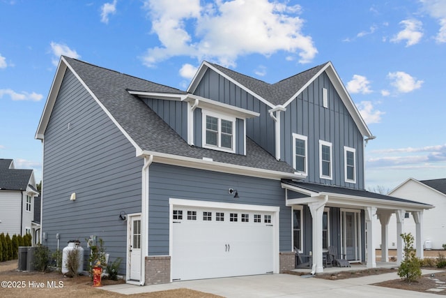 view of front of home with brick siding, board and batten siding, a shingled roof, covered porch, and driveway