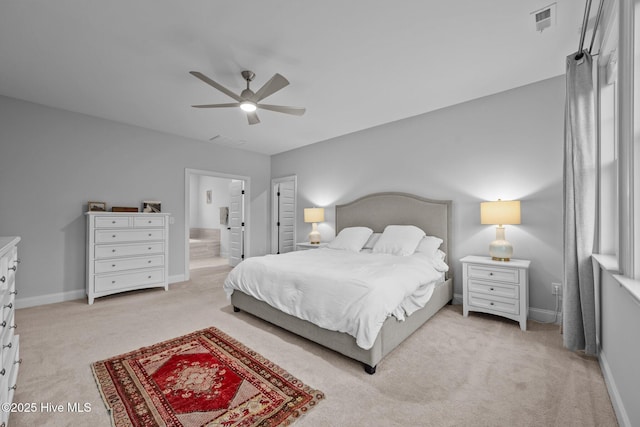 bedroom featuring visible vents, light colored carpet, and baseboards