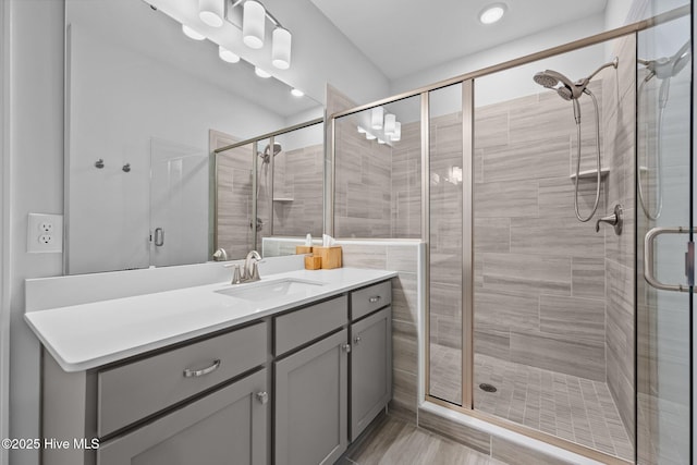 bathroom featuring a shower stall and vanity