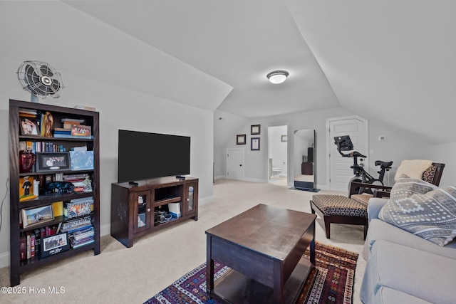 carpeted living area featuring baseboards and lofted ceiling