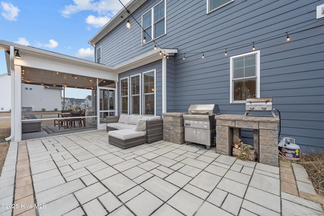 view of patio with grilling area, area for grilling, and a sunroom