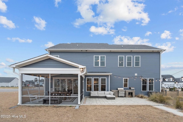 back of house featuring outdoor lounge area, a patio, and a sunroom