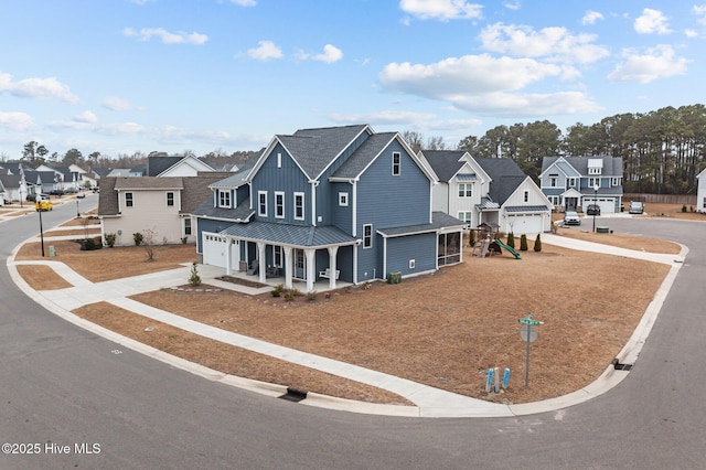 view of front facade featuring a residential view, board and batten siding, concrete driveway, and a standing seam roof