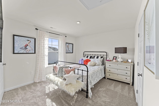 carpeted bedroom featuring attic access, baseboards, and visible vents