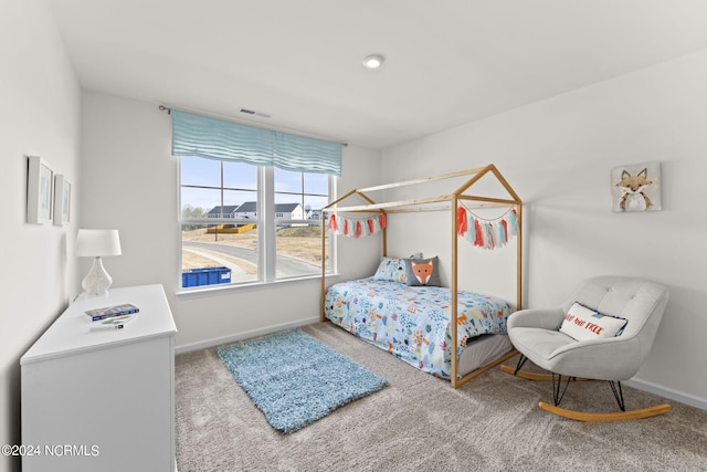 carpeted bedroom featuring visible vents and baseboards