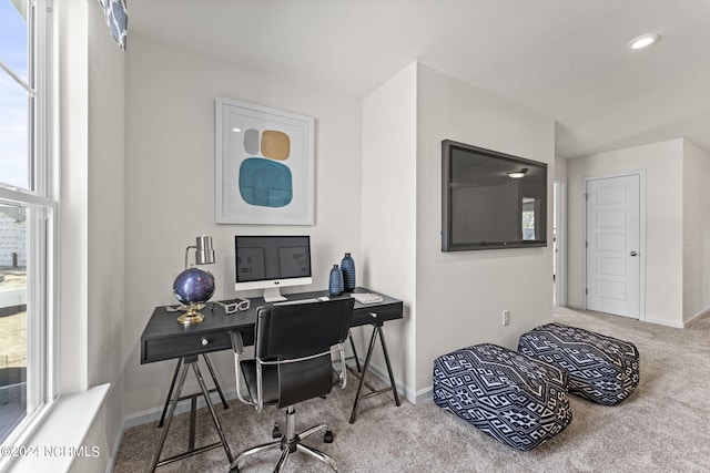 carpeted office space featuring a healthy amount of sunlight and baseboards