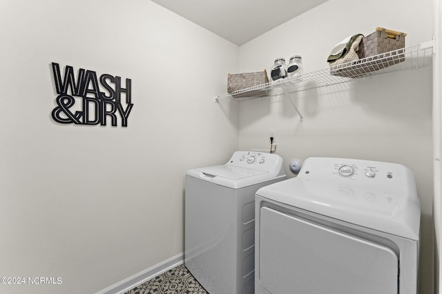 laundry area featuring baseboards, laundry area, and washer and clothes dryer