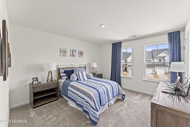 bedroom with carpet, visible vents, and baseboards