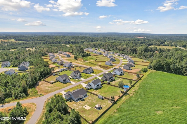 drone / aerial view featuring a wooded view