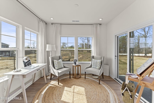 sunroom / solarium featuring visible vents and plenty of natural light