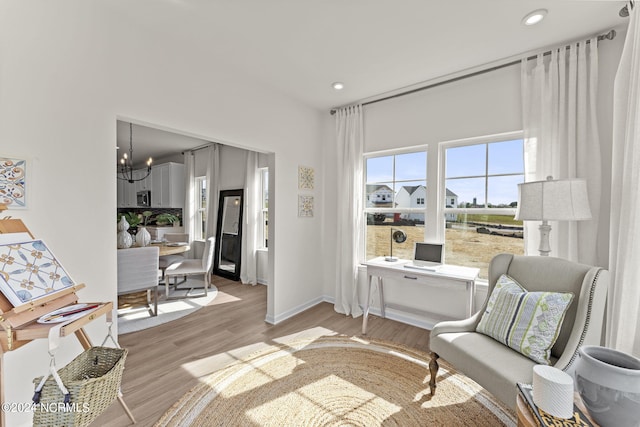 sitting room with an inviting chandelier, recessed lighting, baseboards, and light wood finished floors