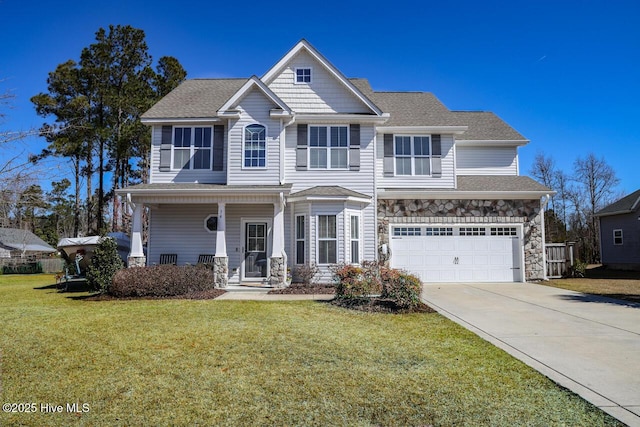 view of front of property with stone siding, covered porch, concrete driveway, an attached garage, and a front yard