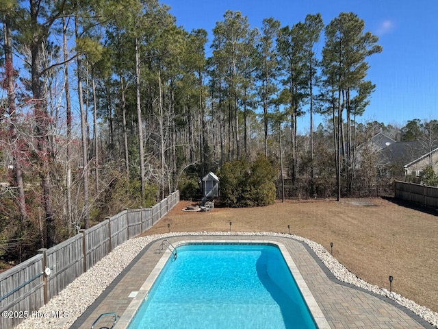 view of pool featuring a yard, a fenced in pool, and a fenced backyard