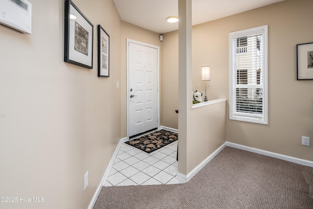 doorway to outside featuring tile patterned flooring, baseboards, and carpet floors