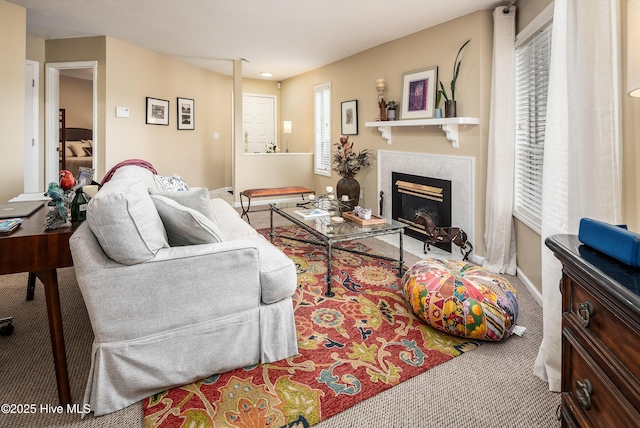 carpeted living room with baseboards and a tile fireplace