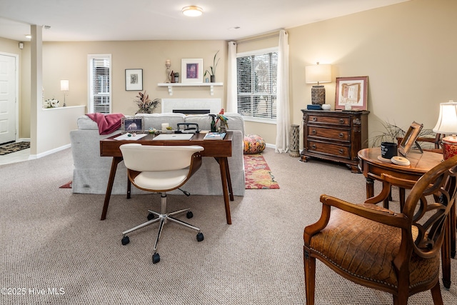 office space with carpet flooring, a fireplace, and baseboards