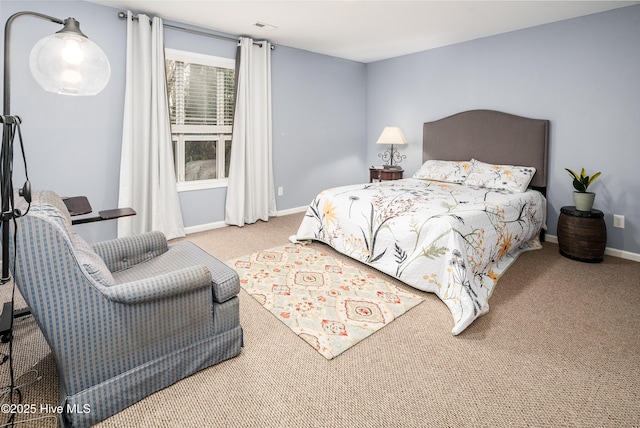 carpeted bedroom with visible vents and baseboards