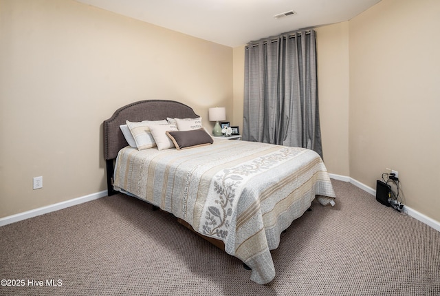 carpeted bedroom featuring visible vents and baseboards