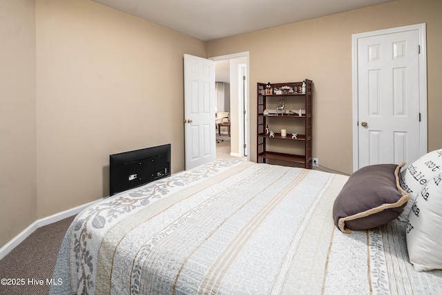 carpeted bedroom featuring baseboards