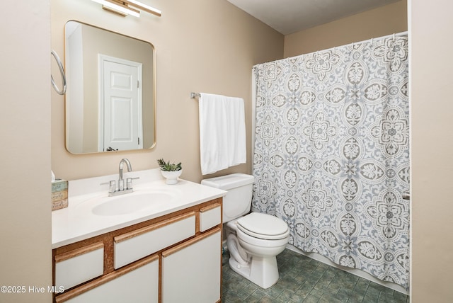 bathroom with vanity, a shower with shower curtain, and toilet